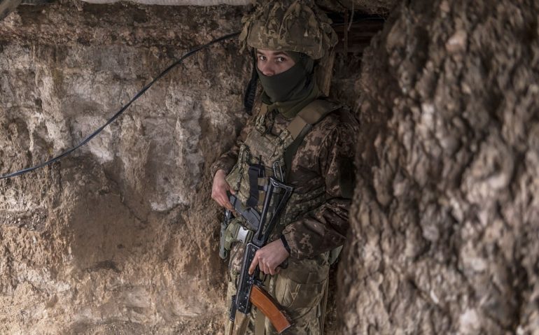NEW YORK, UKRAINE - JANUARY 17: An Ukrainian soldier stands in a trench near the front line on January 17, 2022 in the village of New York, formerly known as Novhorodske, Ukraine. Negotiations last week between Russian and Western diplomats, who were hoping to defuse the prospect of a Russian invasion of Ukraine, ended inconclusively. In recent months, Russia has amassed forces and military equipment near the Ukrainian border, raising the specter of a possible invasion of the country's east, where separatists have waged a nearly 8-year war against the Ukrainian government. (Photo by Brendan Hoffman/Getty Images)