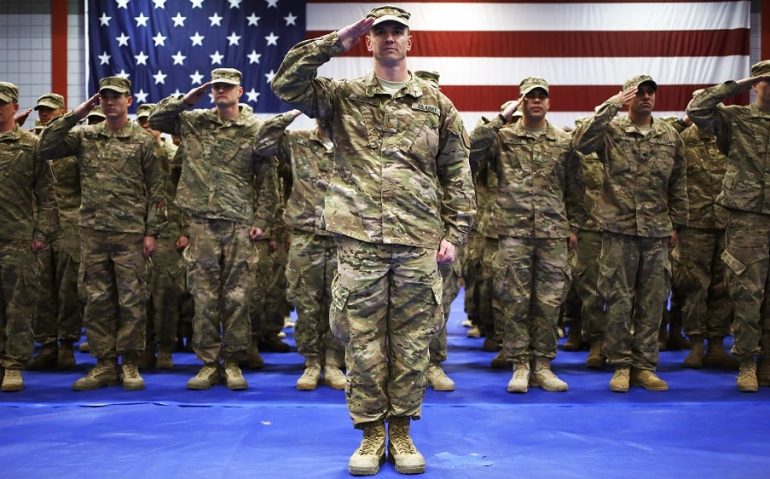 As the U.S. winds down the Afghan war, the government is eyeing a much reduced military force — to its lowest level since World War II. Here, soldiers from the U.S. Army's 3rd Brigade Combat Team, 1st Infantry Division, salute during the playing of "The Star-Spangled Banner" during a homecoming ceremony Feb. 27 in Fort Knox, K
